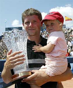 Jiri Novak of the Czech Republic holds the cup and his daughter Katharina after winning the Suisse Open 