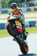Italy's Valentino Rossi wheelstands his Honda in celebration after winning the British MotoGP motorcycling Grand Prix 