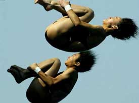 Lao Lishi and Li Ting of China dive their way to win the women's platform synchro competition 