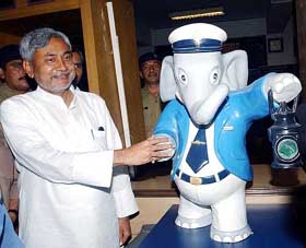 Railway Minister Nitish Kumar shakes hand with the railway mascot 