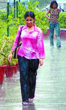Unmindful of the rain, a fresher coyly walks into her college on the second day of the DU session