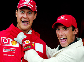 Germany's Michael Schumacher shares a joke with Italian jockey Frankie Dettori