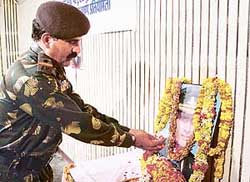 An Army man pays tributes to Capt Atul Somra in Ambala 