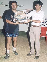Captain of Ernst and Young Akash Mohan receiving the Gold Plate Trophy of the Corporate Cup Soccer Tournament