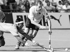 German's Christoph Bechmann fights for the ball with Jugraj Singh of India 