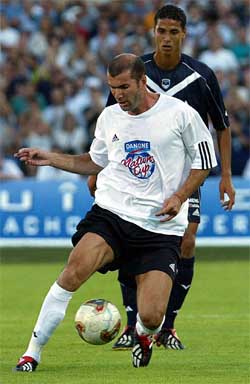French player Zinedine Zidane fights for the ball with Marouane Chamakh 