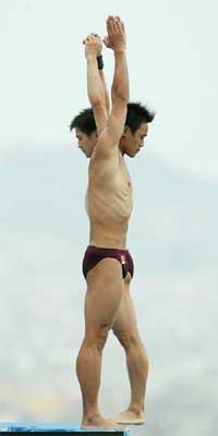 Chinas Jia Hu and Liang Tiang dive in the mens synchronised 10 metres platform preliminaries