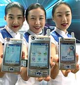 South Korean promoters show Samsung Electronics' new "MITs M400" mobile phones
