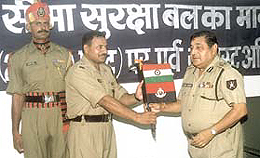 Border Security Force director-general Ajai Raj Sharma handing over the BSF flag to mountaineering expedition leader N S Satish Chandran Nair before the team was flagged off for Mt. Mana from the CGO complex on Monday.