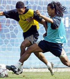 FC Barcelonas new Brazilian recruit Ronaldinho battles for the ball with team-mate Michael Reiziger
