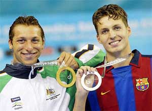 Australia's Ian Thorpe, gold medallist  in the men's 200 metre freestyle event, shows his medal alongside silver medallist Pieter van den Hoogenband of the Netherlands