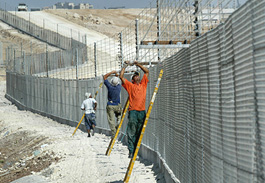 Worker work on Israel's controversial separation fence