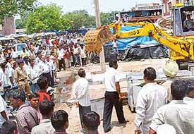 A demolition drive in progress at Grain Market, Sector 26