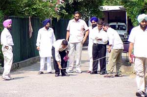 Officials of the Punjab Vigilance Bureau measure the pathway