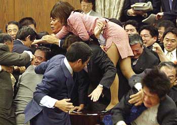 Opposition lawmakers swarm to a chairman to stop the passage of the Iraq Bill