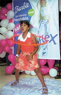 HAVING A BALL: A girl performing a hoopla act during the Flex Barbie Fiesta in the Capital on Saturday.