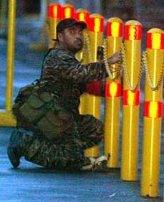 A renegade Philippines soldier sets booby traps in Manilas Makati financial district on Sunday.
