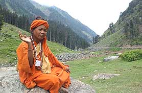 A holy woman waves pilgrims in Chandanwari 