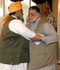 Pakistans Prime Minister Zafarullah Khan Jamali greets Opposition leader Fazalur Rehman