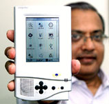Encore Software chairman Vinay Deshpande demonstrates a Simputer