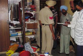 Policemen make an inventory of the stolen goods at the house of an industrialist in Urban Estate, Model Town, Ludhiana