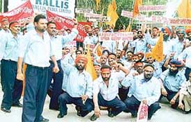 Retrenched workers of Rallis India Limited stage a dharna on the factory premises before submitting a memorandum to the Subdivisional Magistrate