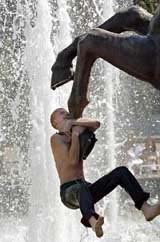A teenager cools himself in a fountain in Moscow