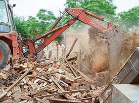 Jhuggis being demolished at Jhotta Kutt Colony in Sector 71, SAS Nagar, on Wednesday.