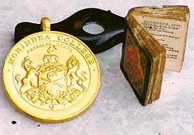 Two of Bhasins prized possessions, a gold medal with mention of Mohindra College Patiala State and a rare handwritten miniature book, that he intends to sell.