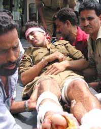 Police constable Shoukat Hussain being carried to a hospital after he was injured in an IED explosion