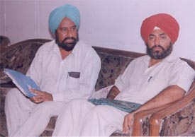 Mr Jagraj Singh Gill and Mr Devinder Singh, both clients of the Ludhiana Improvement Trust, wait for the chairman in his office