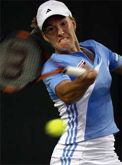 Belgium's Justine Henin-Hardenne returns volley to Eleni Daniilidou of Greece, during second round action at the Acura Classic women's Tennis Championships in Carlsbad