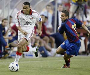 AC Milan's Cafu takes the ball around Barcelona's Mark Overmars