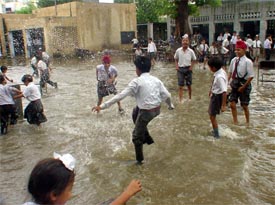 Students of Government Senior Secondary Model School, Model Town, play in water on the school premises after a downpour