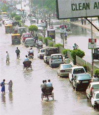 Commuters have a tough time wading through water on National Highway No. 1 in Ludhiana