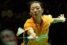 Gong Ruina of China returns to compatriot Zhou Mi during their singles semifinal match at the World Badminton championships 