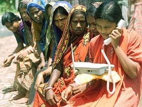 Pratima Mandal, 19, talks to her family members on a WLL mobile phone