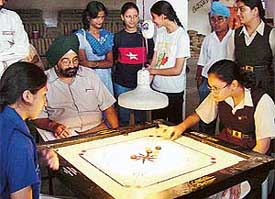 Pallavi Piplani strikes against Harmeet in the VIth St Stephens sub-junior final carrom ranking tournament in St Stephens School