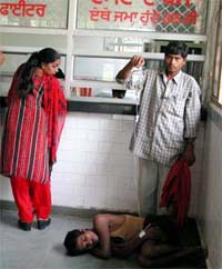 Balinder Kumar lies in the corridor of the new building of civil hospital, Ludhiana, near the cash counter