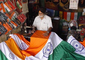 A shopkeeper prepares flags for the forthcoming Independence Day