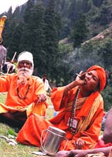 A sadhu enjoys a smoke before starting his journey to the holy cave shrine of Amarnath