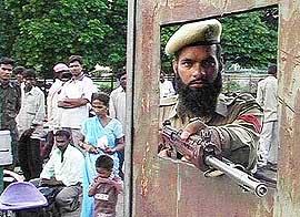 A police personnel keeps strict vigil at the Jammu railway station 