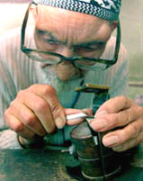 Centenarian Ghulam Nabi Kalwal, a Kashmiri craftsman, engraves on a ring at his workshop in Srinagar 