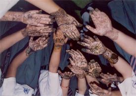 Students of GNI School display mehndi patterns at a competition