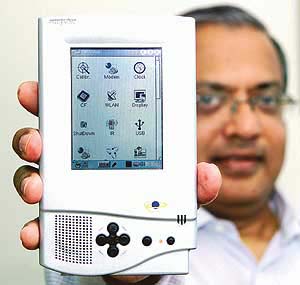 Indian Chairman of Encore Software Ltd Vinay Deshpande holds the Simputer in the southern Indian city of Bangalore. 