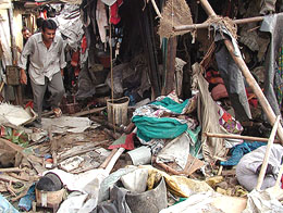 A man walks through the rubble of a house