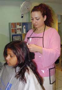 Aseel highlights the hair of a client at Oleega salon
