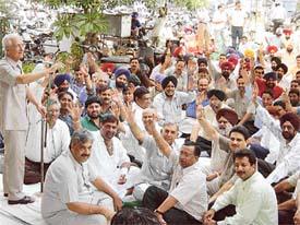 Members of the small-scale industry hold a dharna in Ludhiana