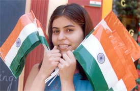A playway schoolteacher just before she distributes the Tricolour among children during Independence Day celebrations