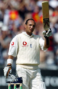 Englands Mark Butcher raises the bat after reaching his century 